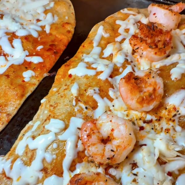 Two Machetes Gourmet shrimp and cheese quesadillas, with melted white cheese and seasoned shrimp.