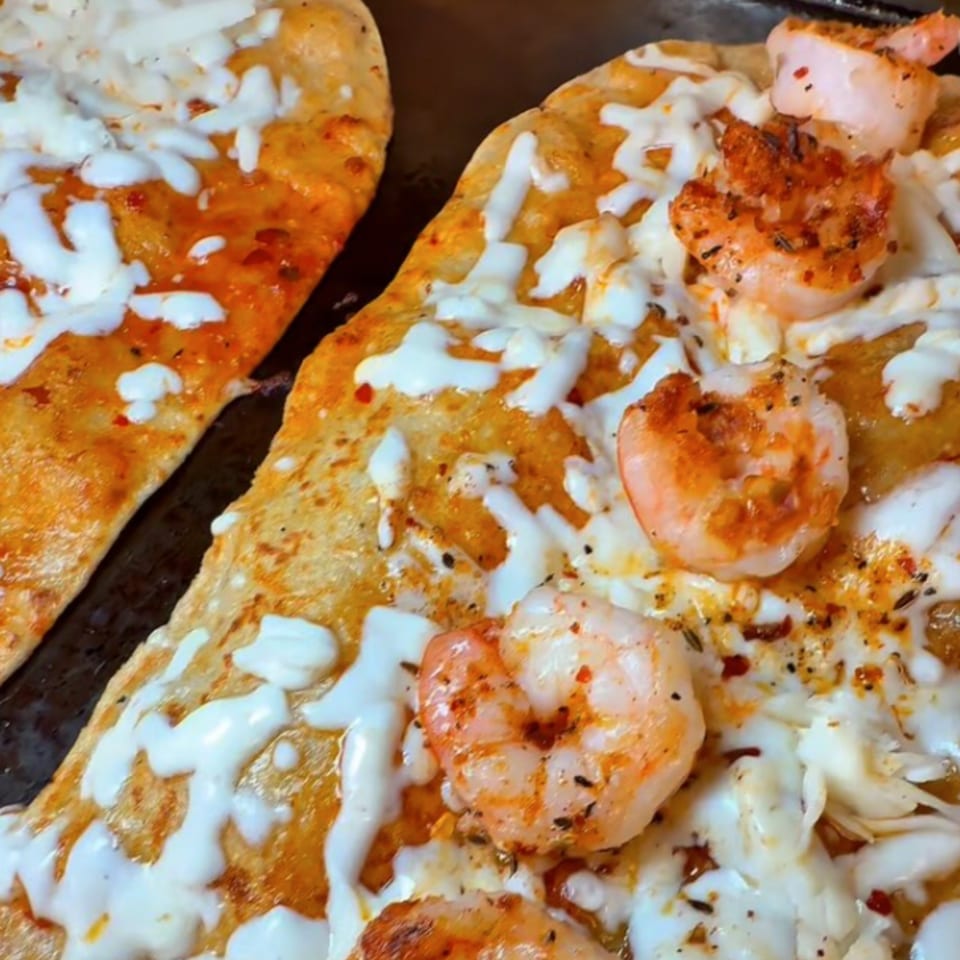 Two Machetes Gourmet shrimp and cheese quesadillas, with melted white cheese and seasoned shrimp.